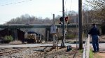 A westbound CSX empty coal train passes underneath the Carter Glass Bridge, US 29 Business.  NS (ex-Southern) Old Main Line veers off uphill to the right.